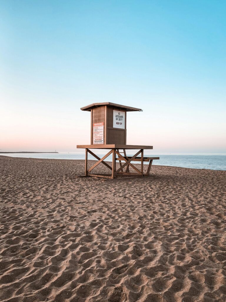 Scenic view of an empty lifeguard tower on Newport Beach, California at sunrise.