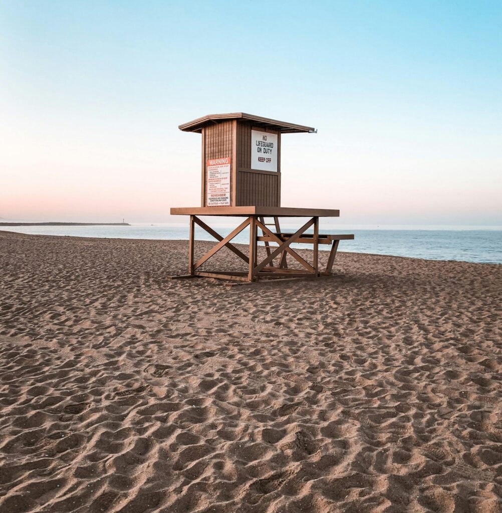 Scenic view of an empty lifeguard tower on Newport Beach, California at sunrise.